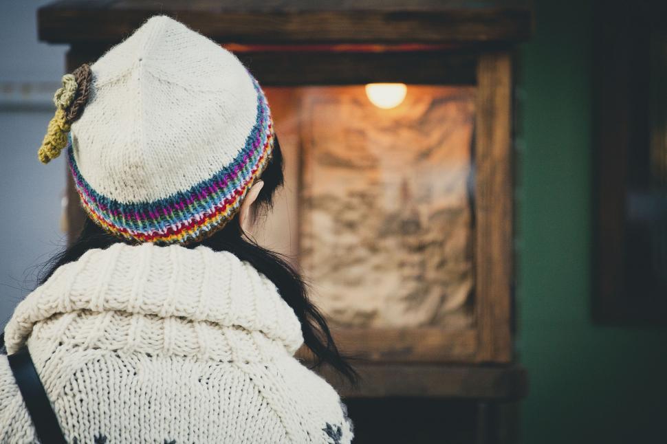 Free Image of Woman viewing an art piece in a warm light 