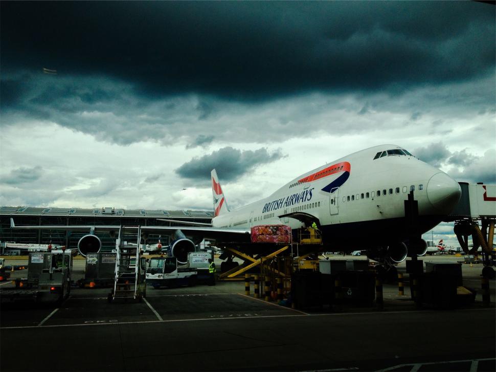 Free Image of Commercial airplane at airport loading cargo 