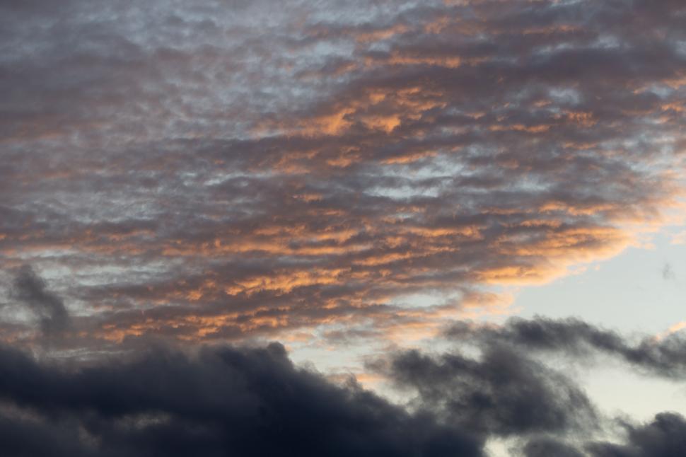 Free Image of Fiery sunset clouds over serene sky 