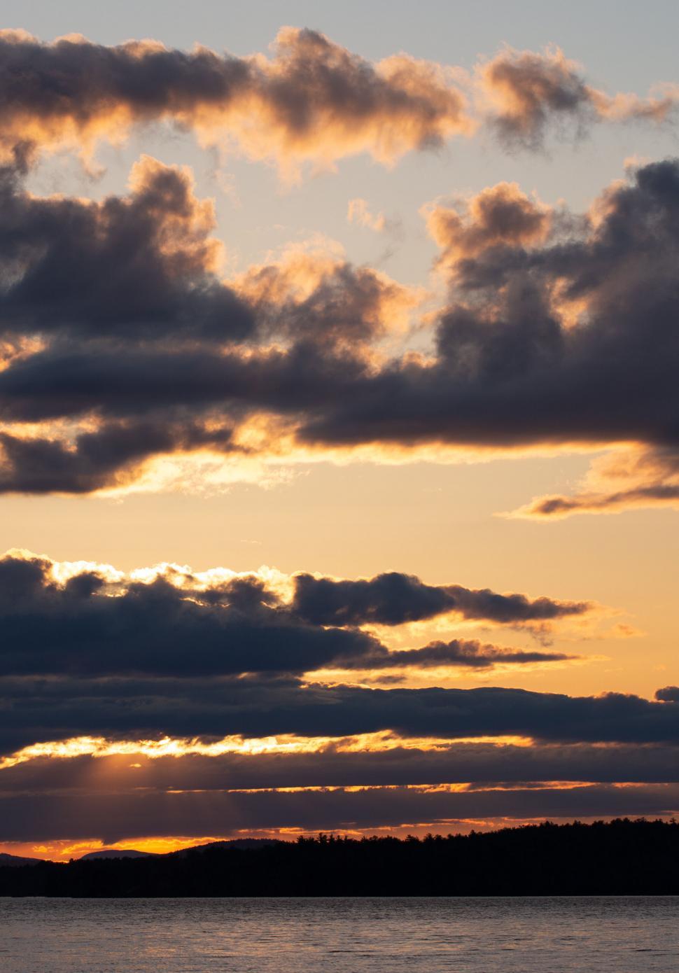 Free Image of Sunset cloudscape over a calm lake 