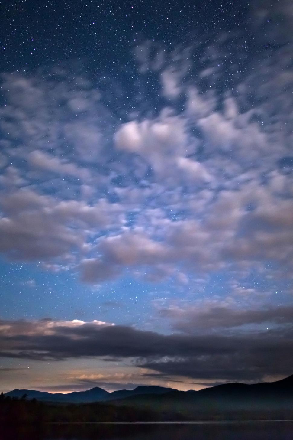 Free Image of Starry night sky over silhouetted mountains 