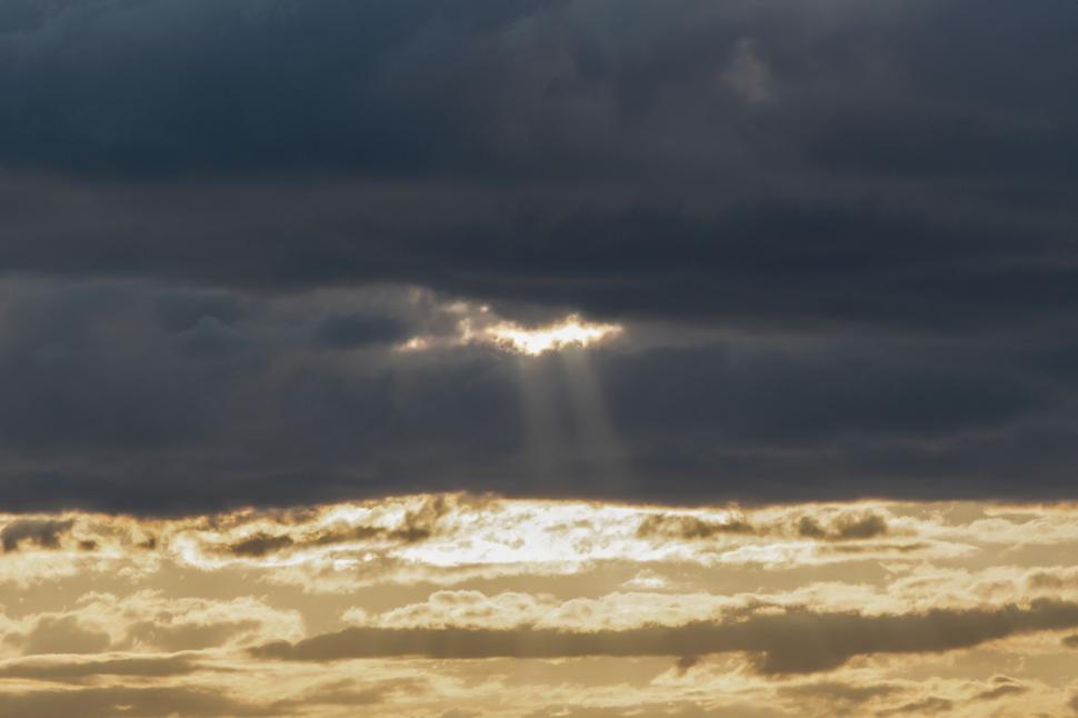 Free Image of Sunbeams breaking through stormy clouds 