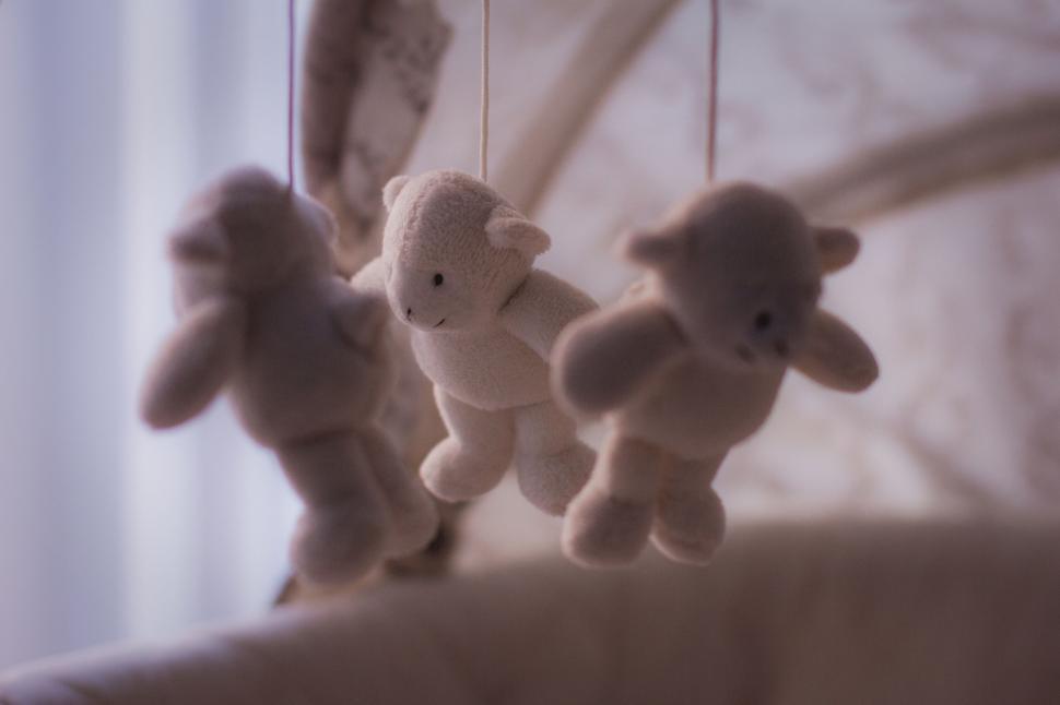 Free Image of Plush animal mobile hanging over a crib 