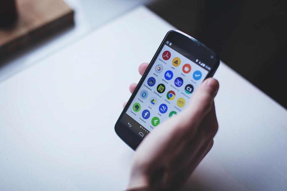 Free Image of Smartphone with colorful app icons in hand 