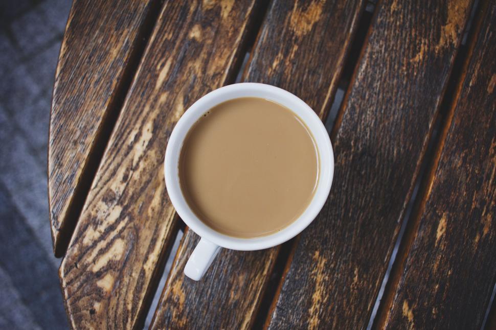 Free Image of Coffee cup on rustic wooden table top 