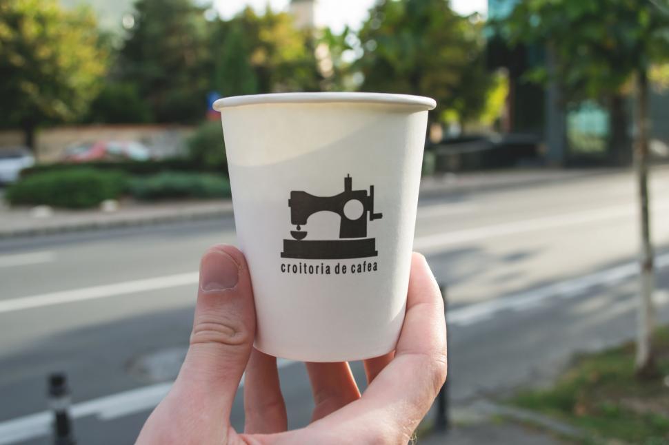 Free Image of Paper coffee cup with sewing machine logo 