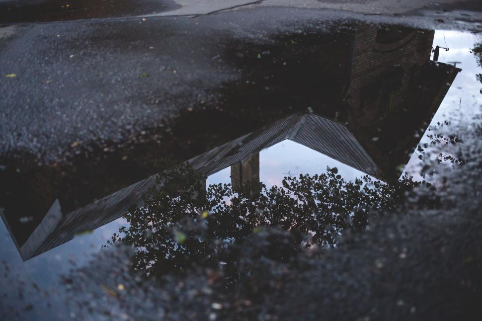 Free Image of Puddle reflection of a house and sky 