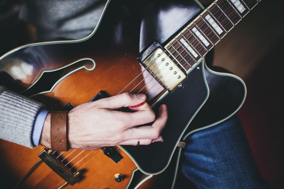 Free Image of Close-up of musician playing on a guitar 