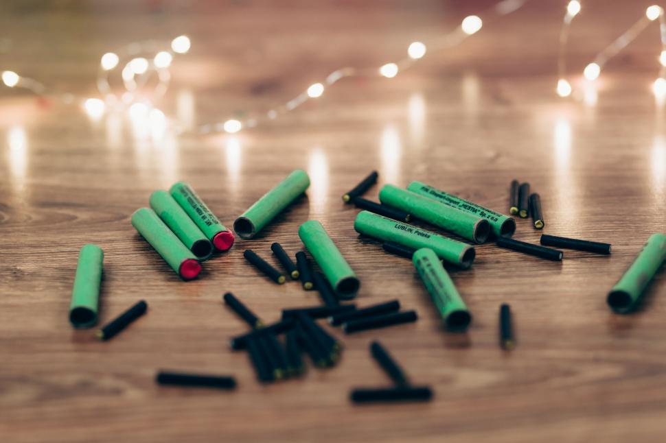 Free Image of Spent shotgun shells on wooden table 