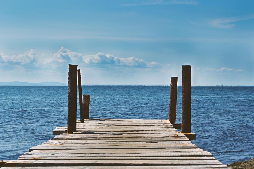 Free Image of Wooden pier leading into calm ocean 