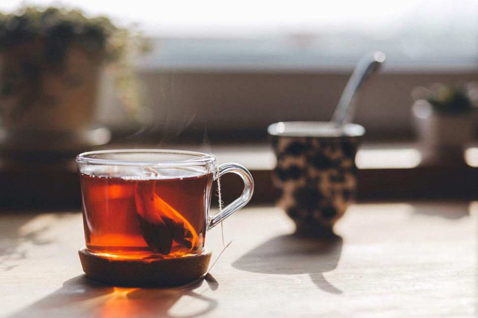 Free Image of Steaming tea cup on a sunny morning 