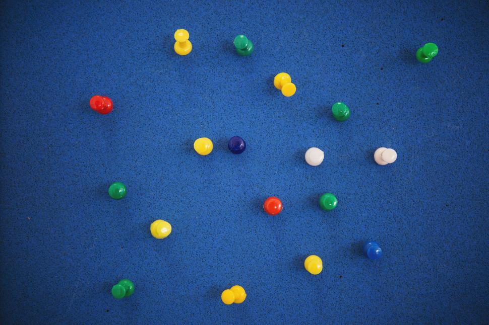 Free Image of Colorful climbing knobs on a blue wall 