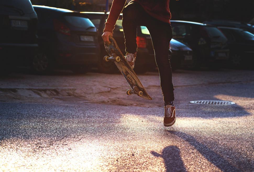 Free Image of Skateboarder performing a trick at sunset 