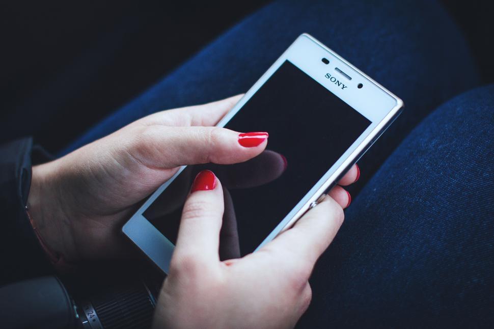 Free Image of Person texting on a Sony smartphone 
