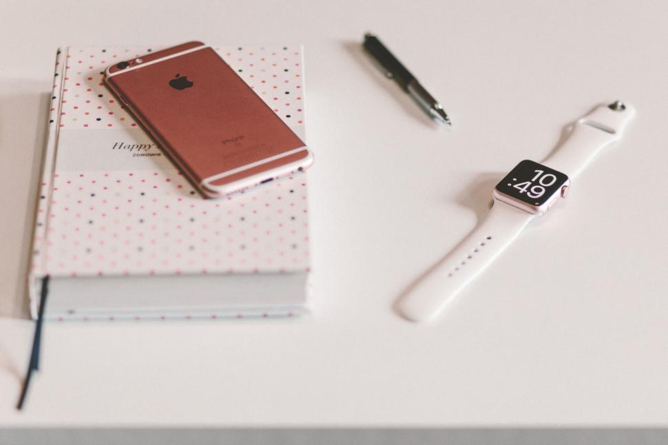 Free Image of iPhone and Apple watch on a table 