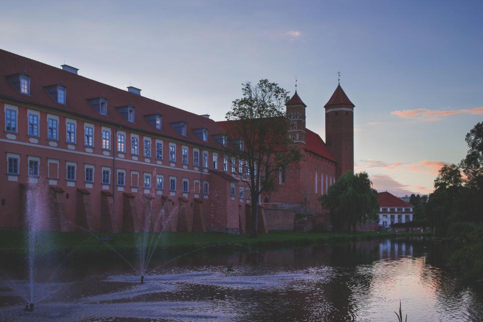 Free Image of Magnificent castle by the water at dusk 