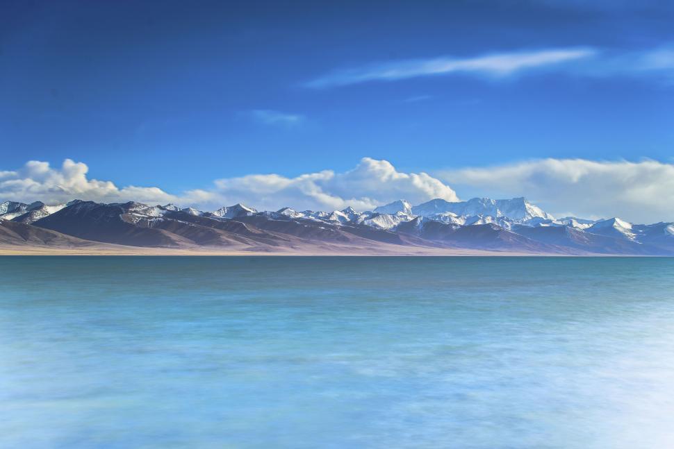 Free Image of Calm sea with mountainous horizon line 
