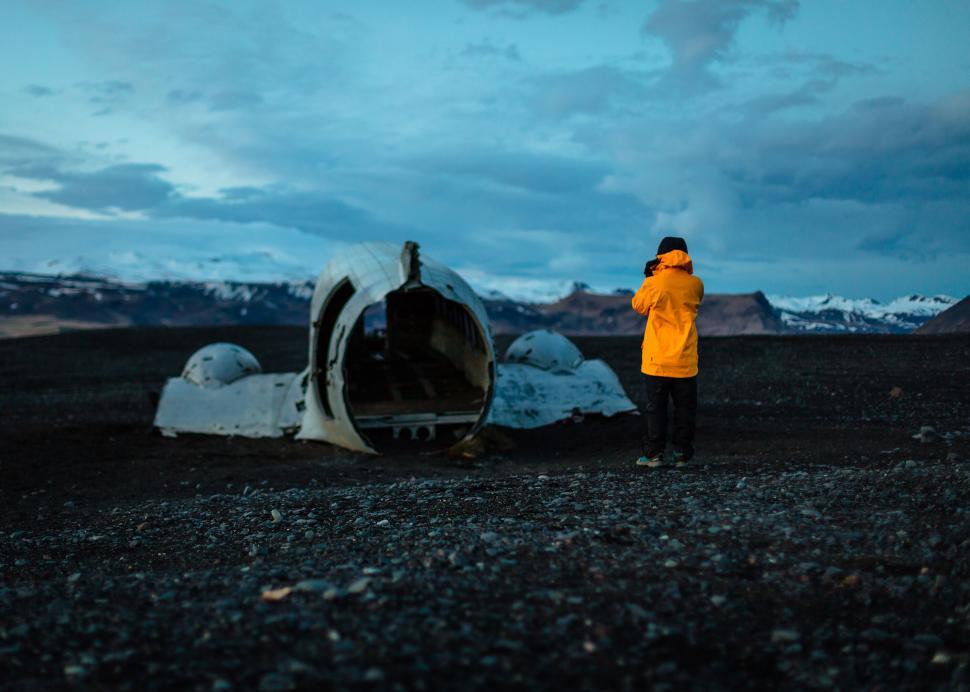 Free Image of Person observing a plane wreck at dusk 