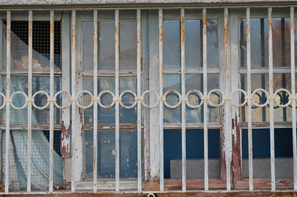 Free Image of Rusted iron window grill with circular pattern 