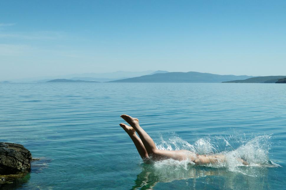 Free Image of Person diving into serene blue water 