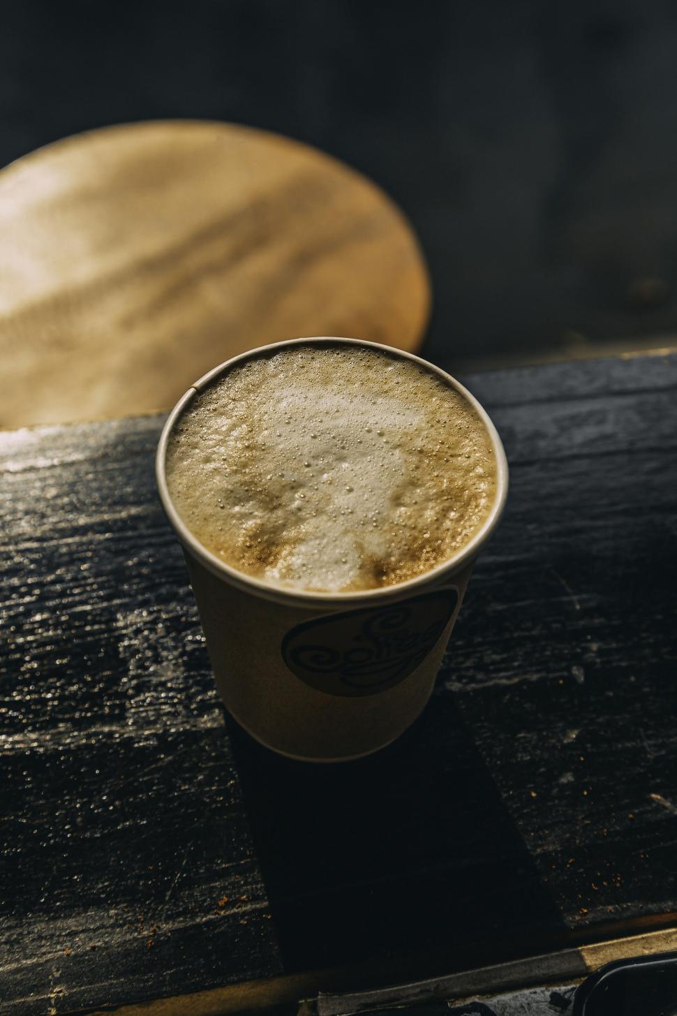 Free Image of Takeaway coffee cup on wooden table 