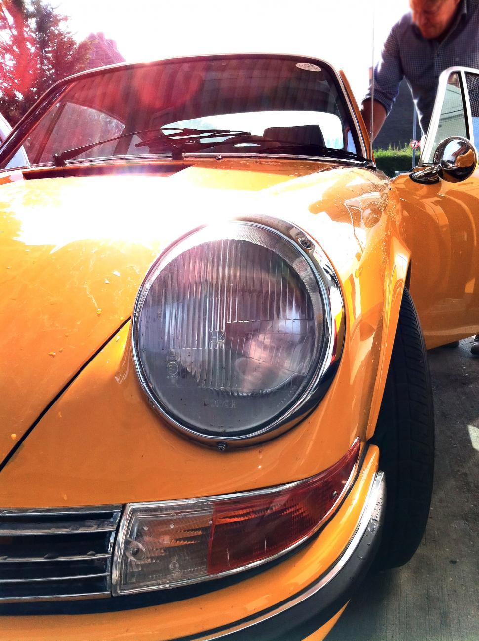 Free Image of Close-up of vintage yellow sports car 