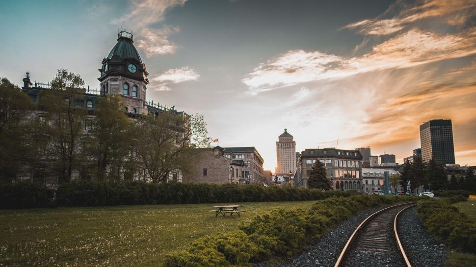 Free Image of Historic building and railway at golden hour 