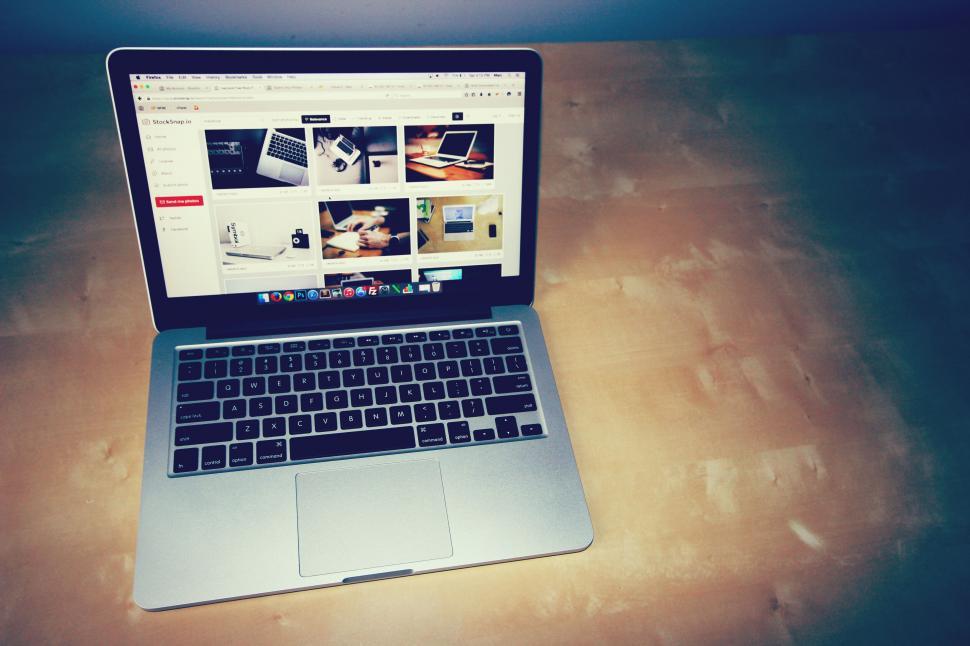 Free Image of Laptop on a desk with image search on screen 
