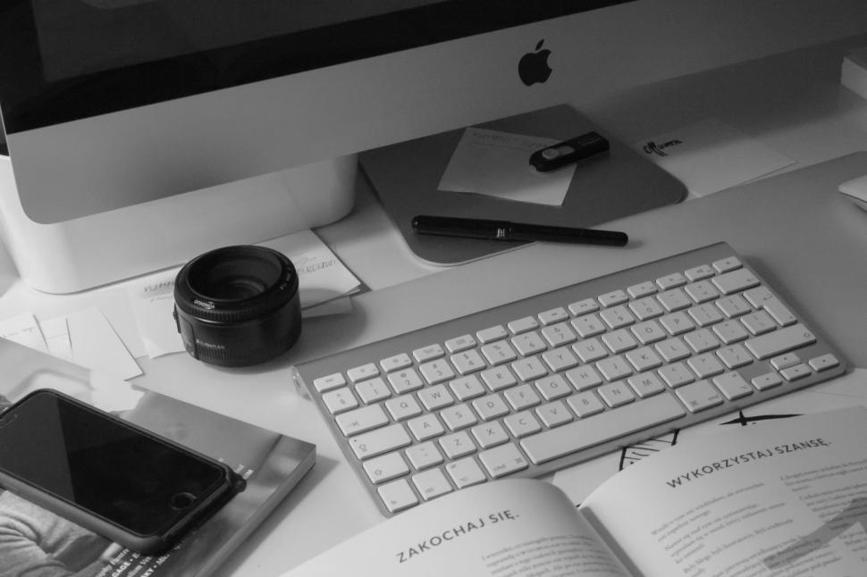 Free Image of Modern workspace with computer and camera lens 