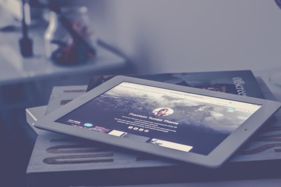 Free Image of Tablet displaying website on a wooden stand 
