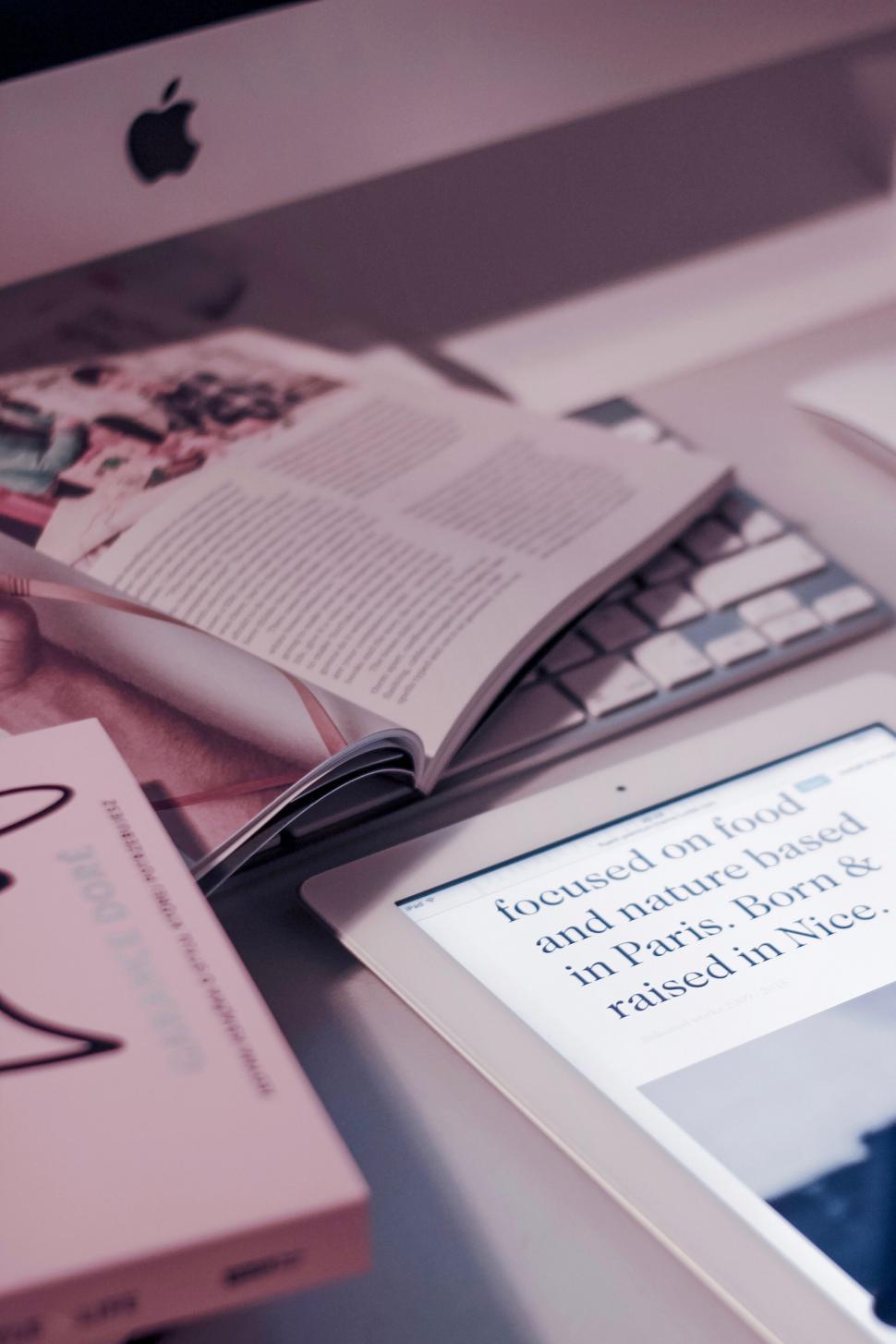 Free Image of Open book on Apple Macbook keyboard 