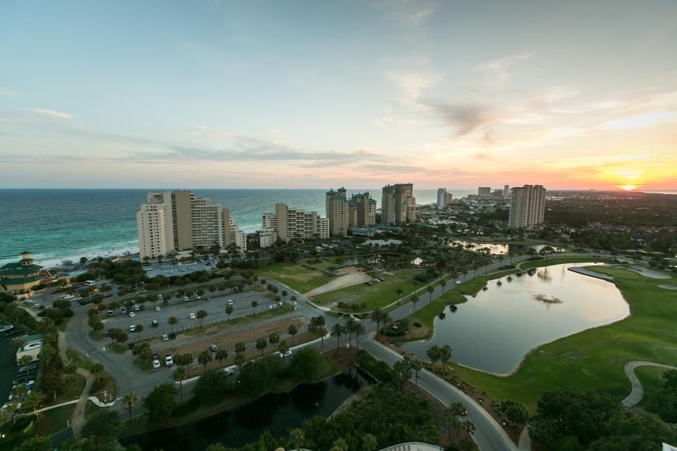 Free Image of Aerial view of cityscape at sunset near coast 