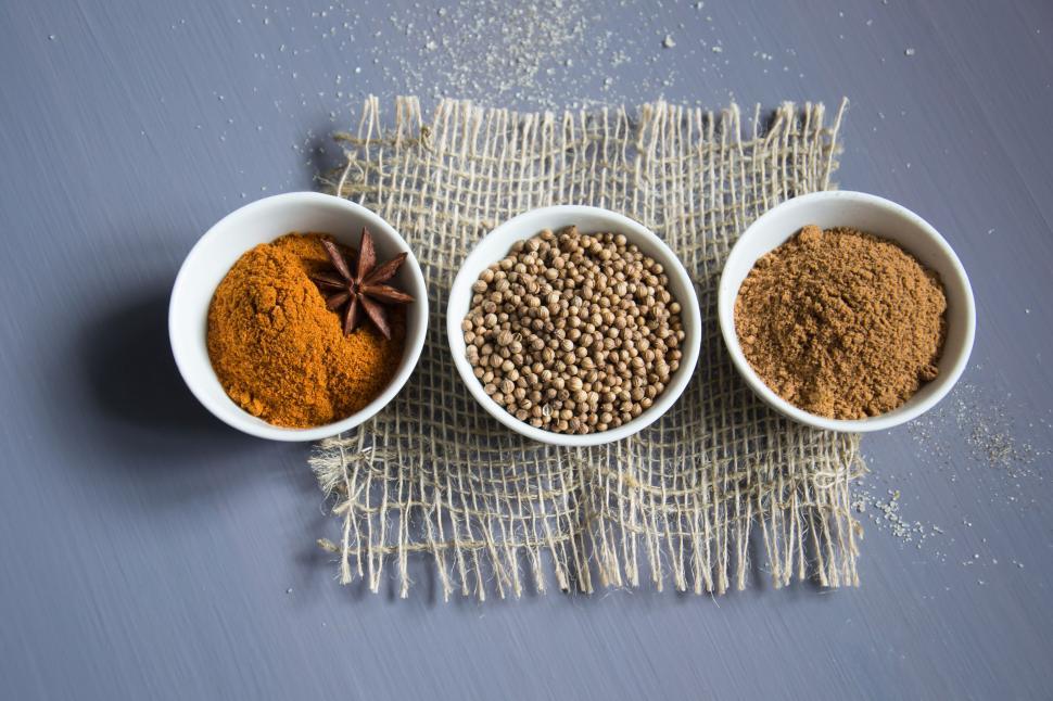 Free Image of Assorted spices in white bowls on rustic fabric 