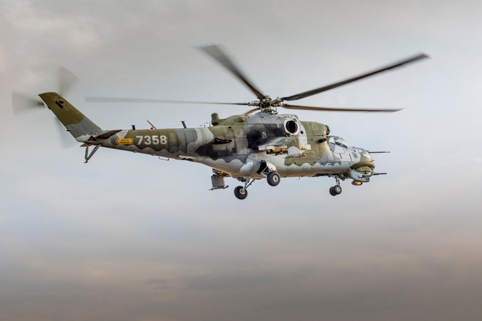 Free Image of Military helicopter flying in cloudy sky 
