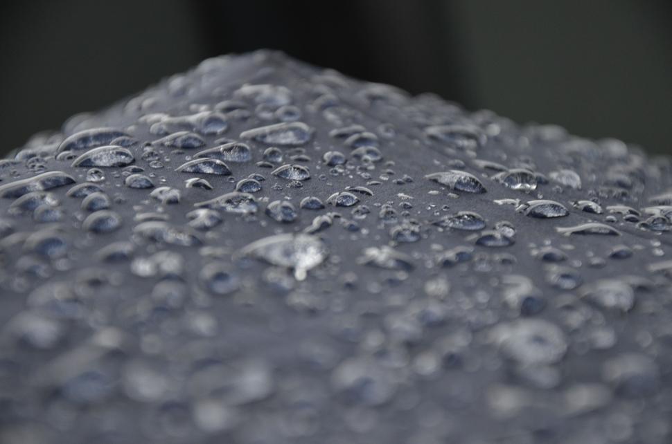 Free Image of Dark umbrella with water droplets close up 