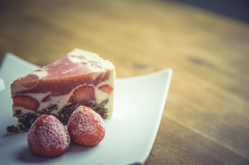 Free Image of Strawberry cheesecake slice on white plate 