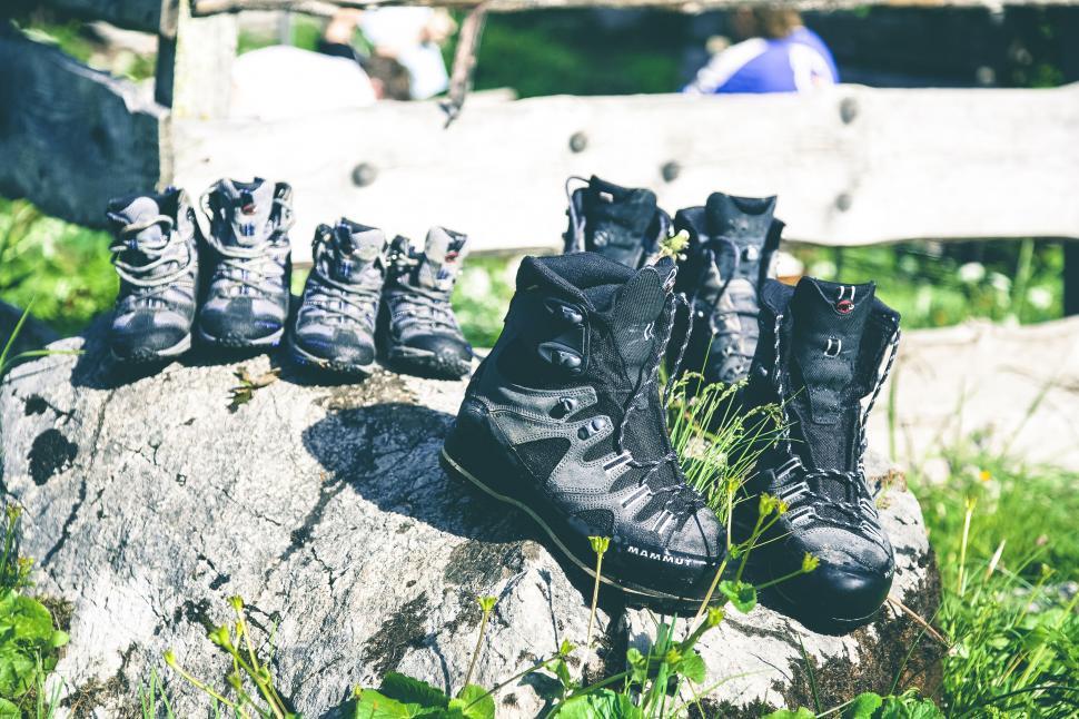 Free Image of Hiking boots aligned on a rock in nature 