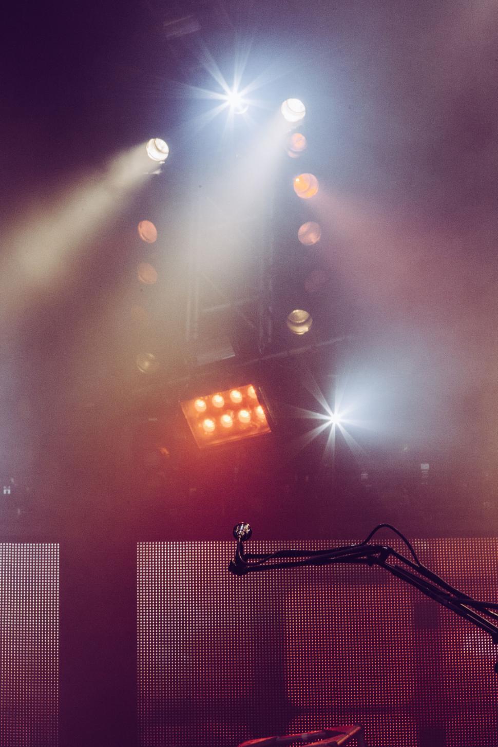 Free Image of Concert stage lights with microphone in front 