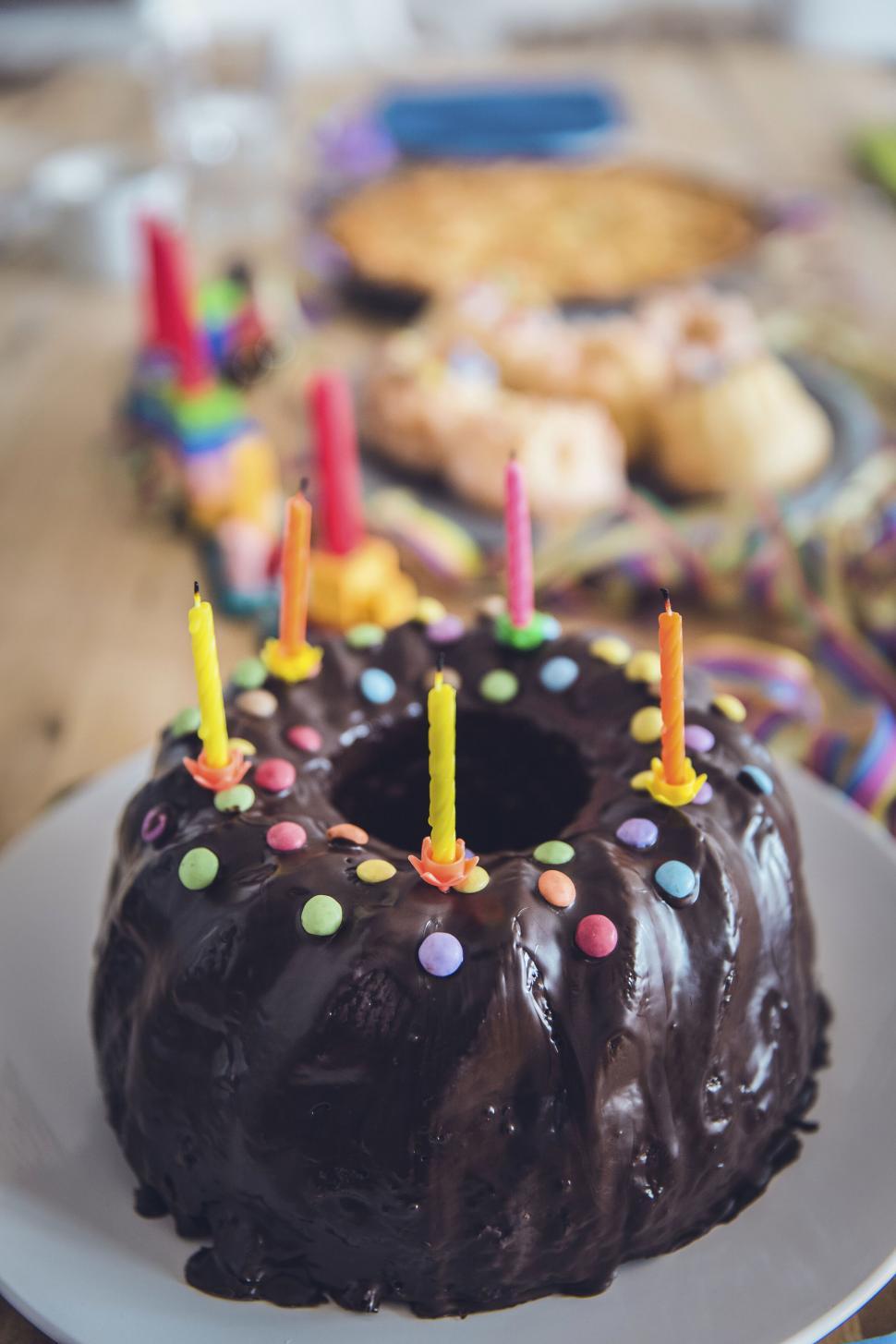 Free Image of Birthday cake with lit candles and decor 