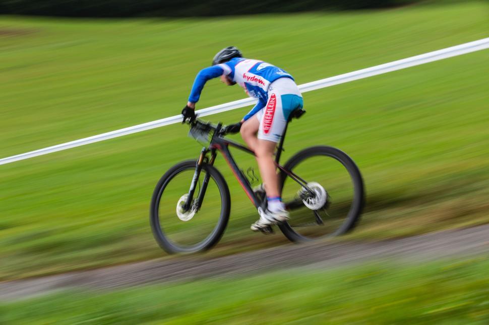 Free Image of Cyclist in motion blur racing on track 