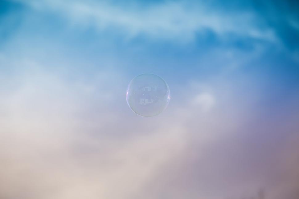 Free Image of Single soap bubble floating against blue sky 