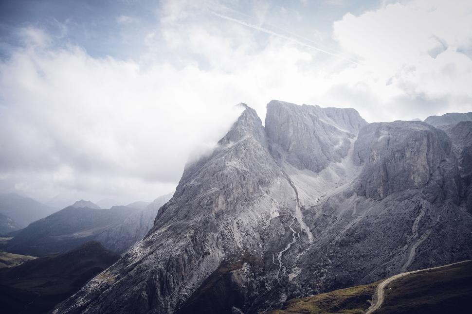 Free Image of Majestic mountain peak against a cloudy sky 