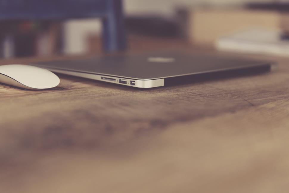 Free Image of Sleek laptop on a wooden desk 