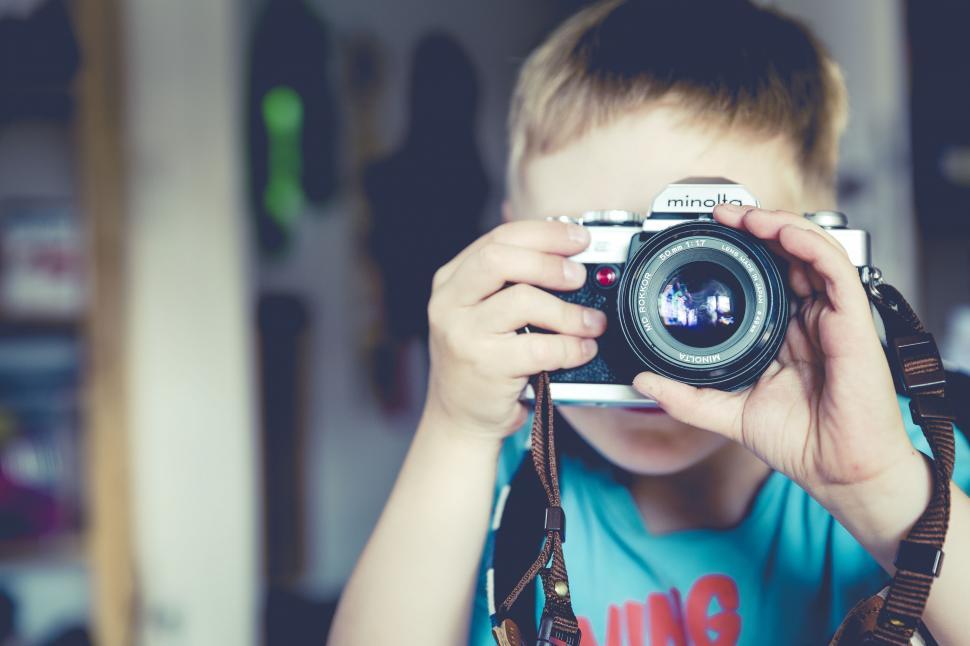 Free Image of Blurred face Child holding a camera 