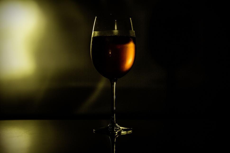 Free Image of Silhouette of a wine glass against a dark background 