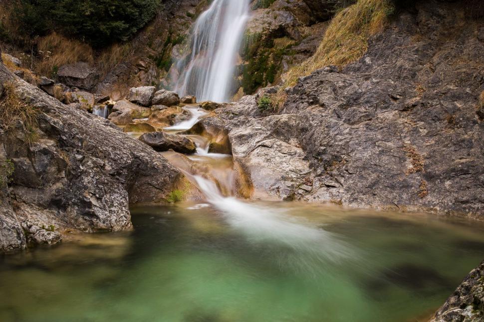 Free Image of Cascading waterfall over smooth rocks in nature 