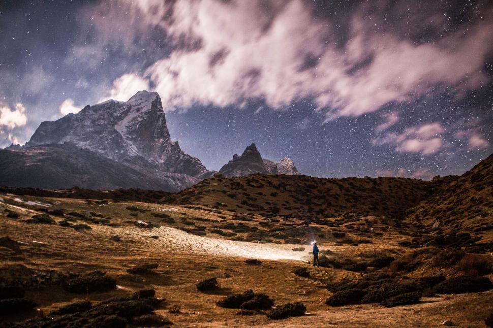 Free Image of Starry night over rugged mountain terrain 