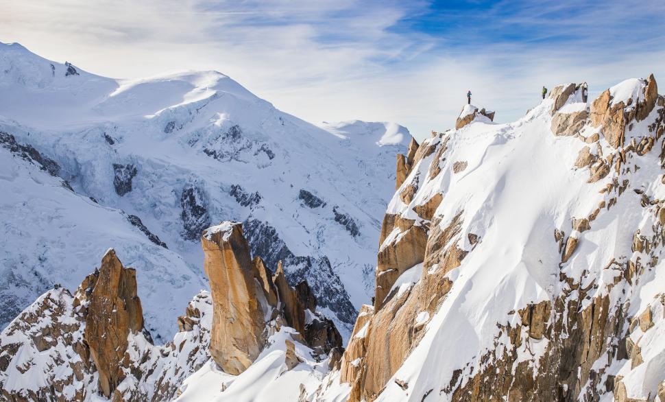 Free Image of Mountaineer overlooking a snowy mountain range 