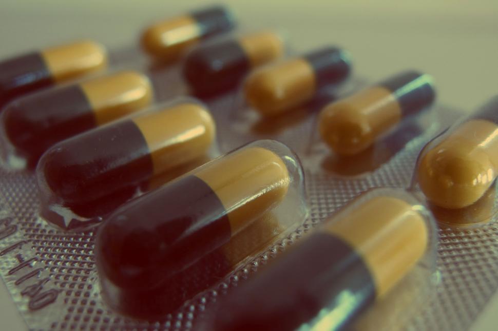 Free Image of Blister pack of yellow and black capsules 