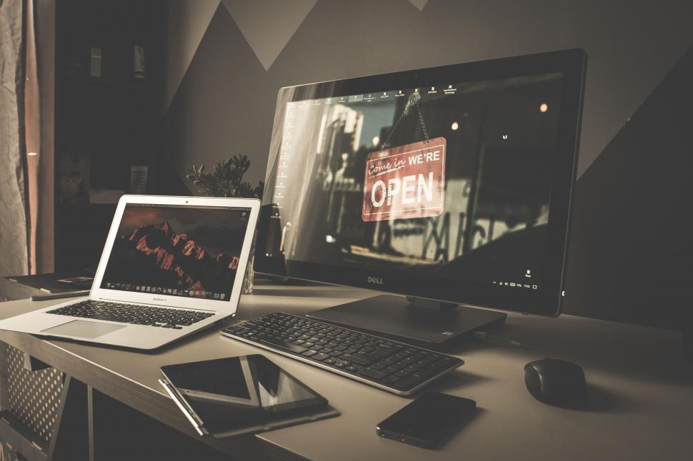 Free Image of Modern workspace with multiple screens displaying OPEN 